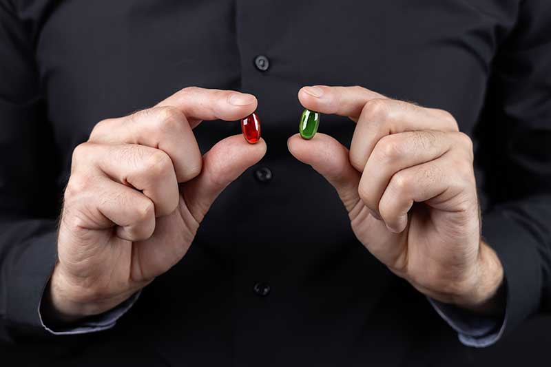 hands-holding-red-and-green-capsules-colin-austin-gbiota