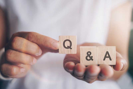 hands-holding-q-and-a-wooden-cubes-colin-austin-gbiota