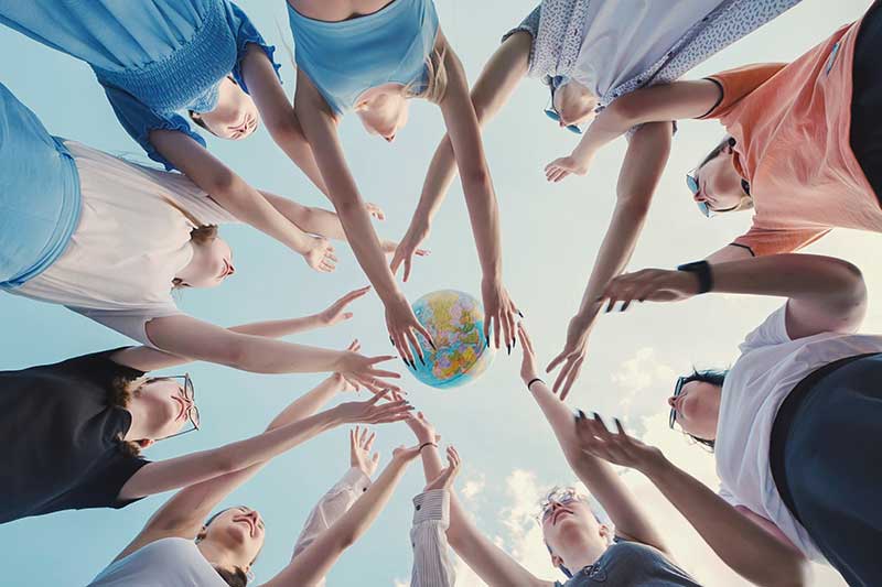 people-reaching-for-globe-global-citizenship-symbol-colin-austin-gbiota